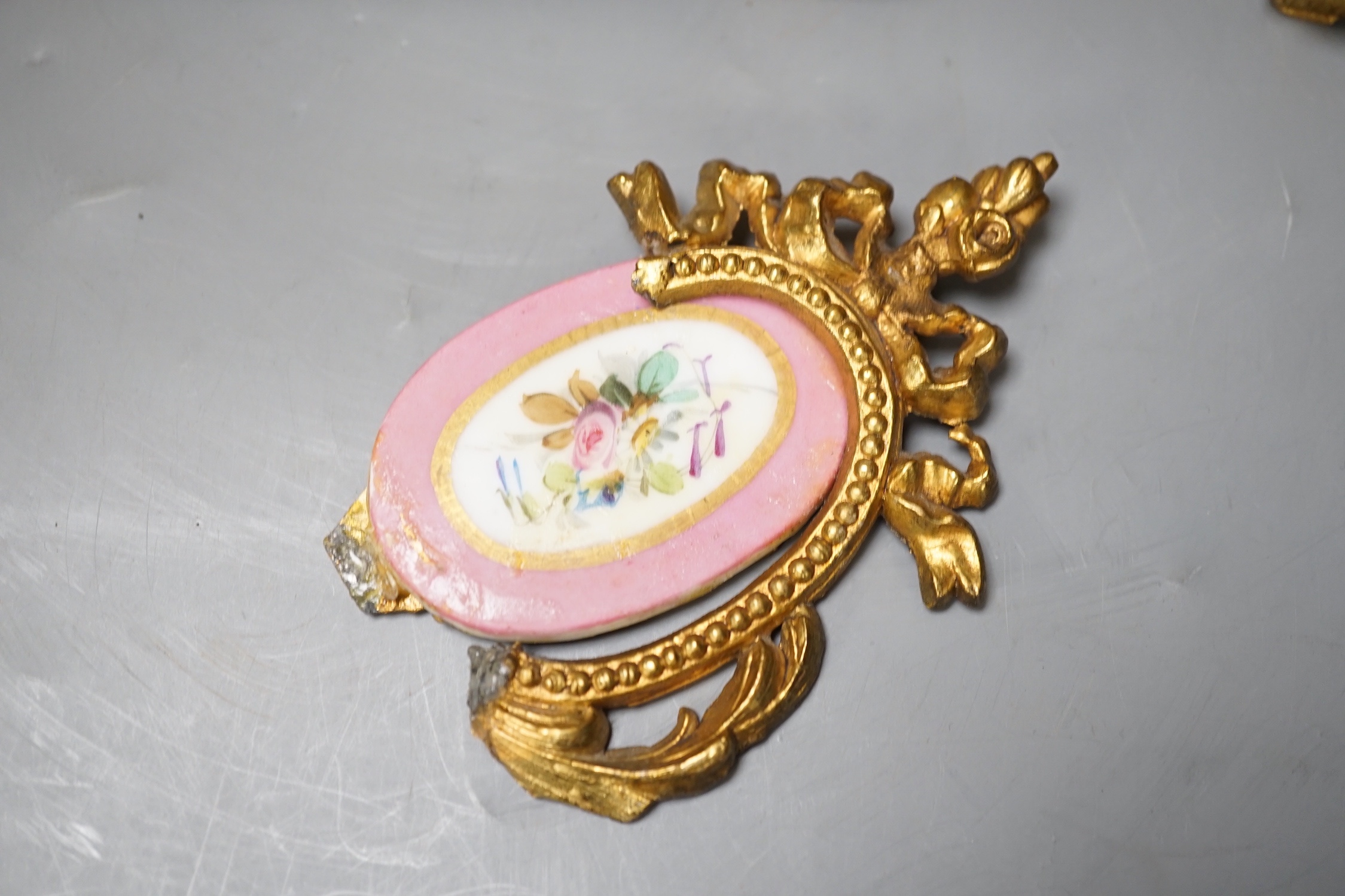 A French gilt metal and porcelain clock garniture. 36.5cm